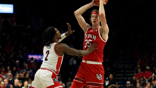 Jan 6, 2024; Tucson, Arizona, USA; Utah Utes center Branden Carlson (35) makes a pass against Arizona Wildcats guard Caleb Love (2) during the first half at McKale Center. Mandatory Credit: Zachary BonDurant-USA TODAY Sports